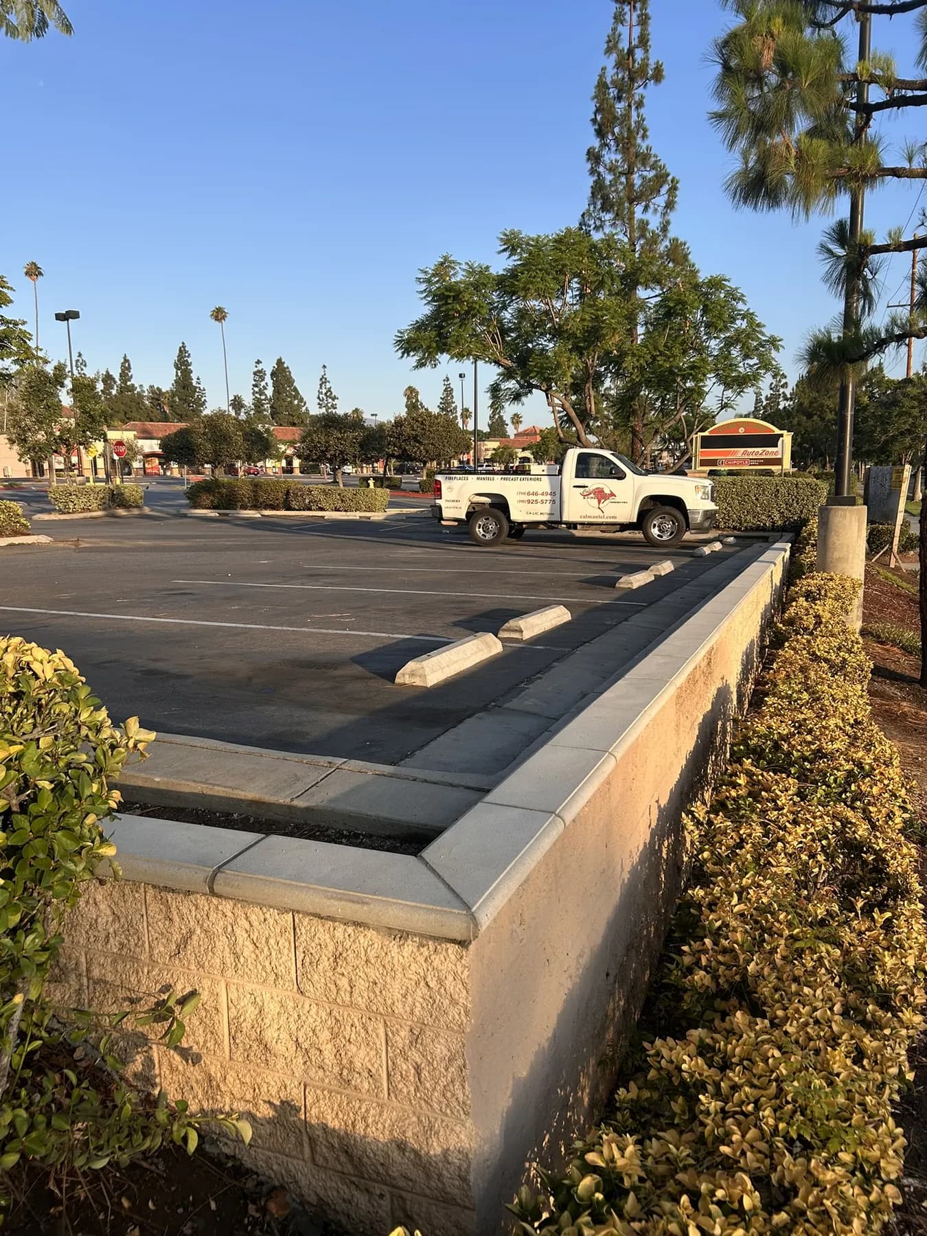 Precast capped block wall along a commercial parking lot