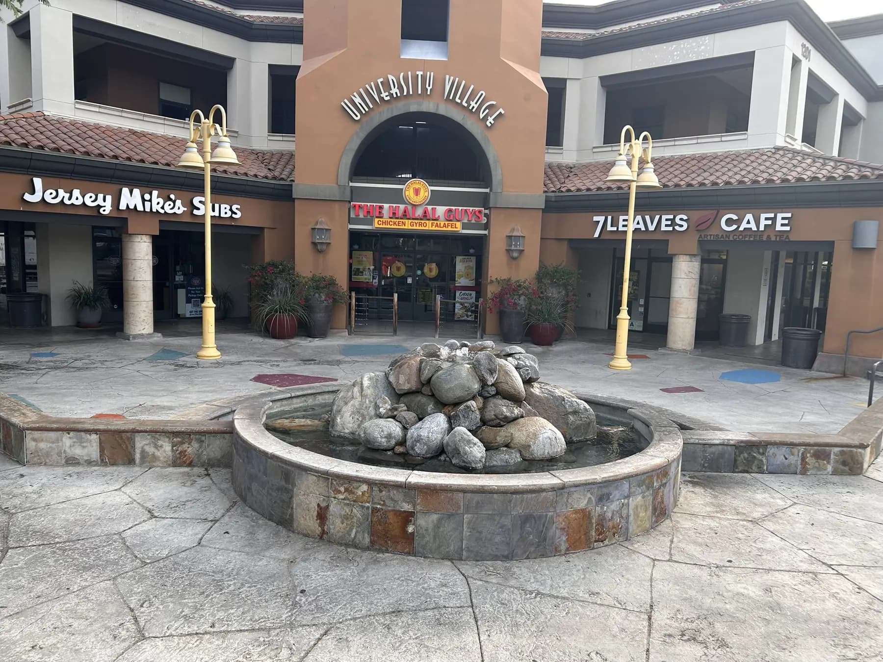 Stone-clad fountain in the University Village retail plaza courtyard